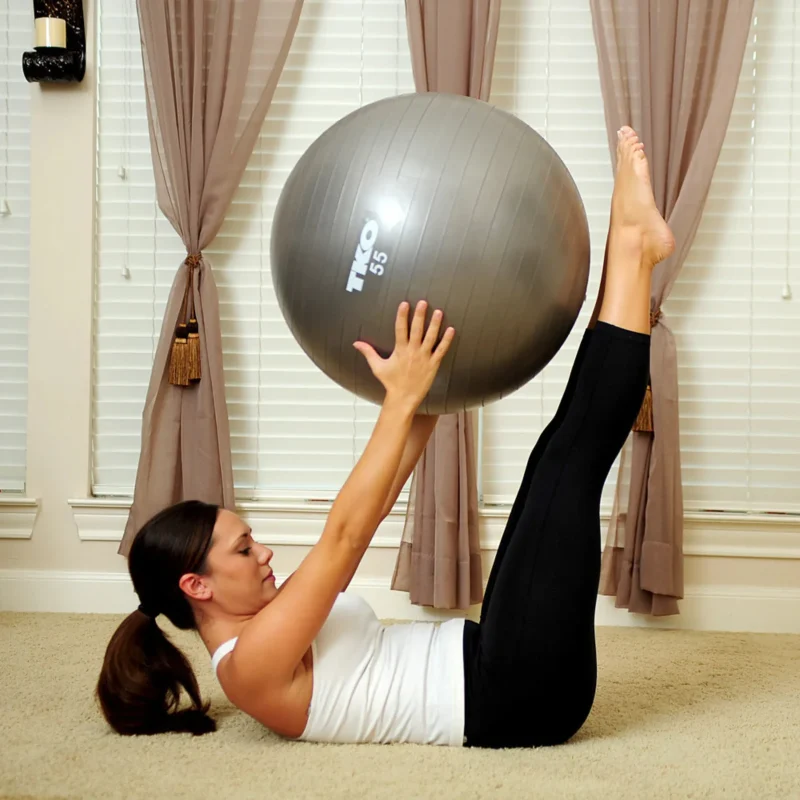 Person performing a plank exercise on the TKO Fitness Ball 55cm, demonstrating its effectiveness for core strengthening and balance in Sharjah, UAE.